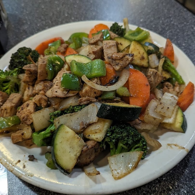George's Shish Kebab chicken and vegetable stir-fry with broccoli, carrots, zucchini, onions, and peppers.